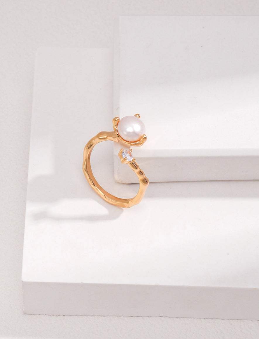 A professional studio shot of the Elora ring in Vintage Gold, highlighting the warm 18K plating and the intricate zircon-studded organic band.